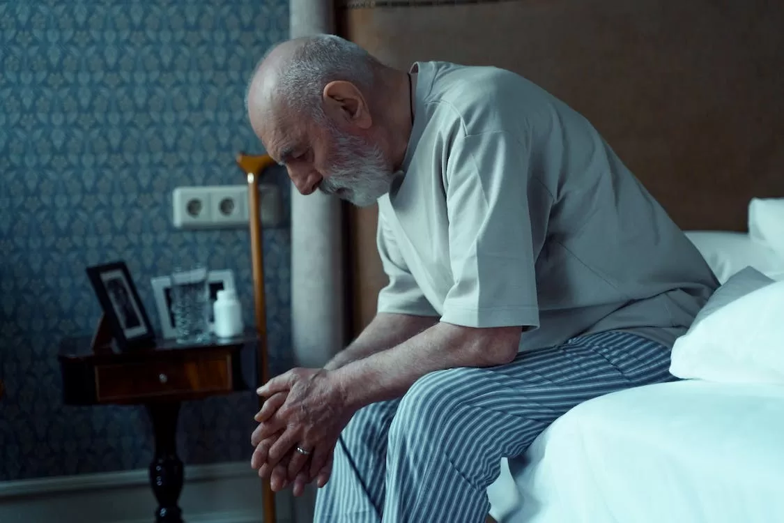 Elderly-Man-Sitting-on-Side-of-Bed - Alaska Sleep Clinic - Alaska Sleep Clinic